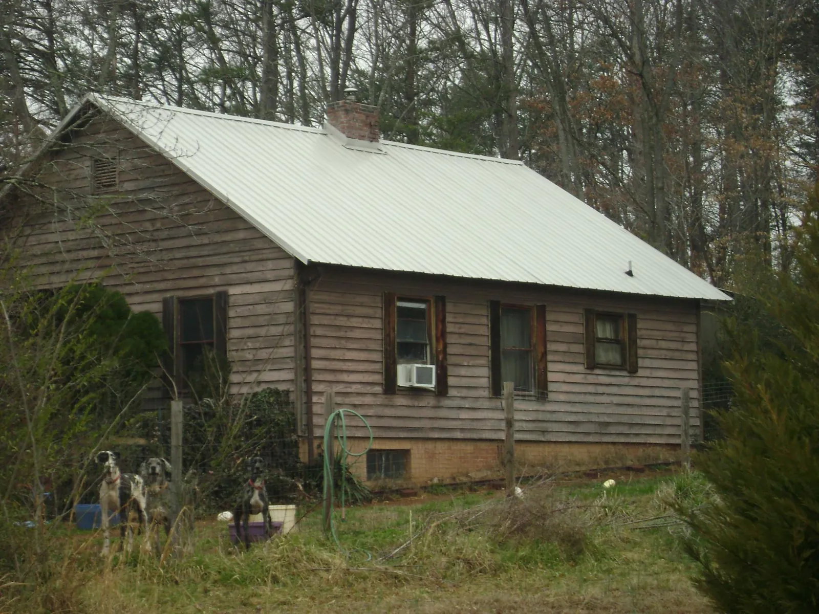 White metal roof on an old wood sided farmhouse, from a Metal Roof Installation job in Albany